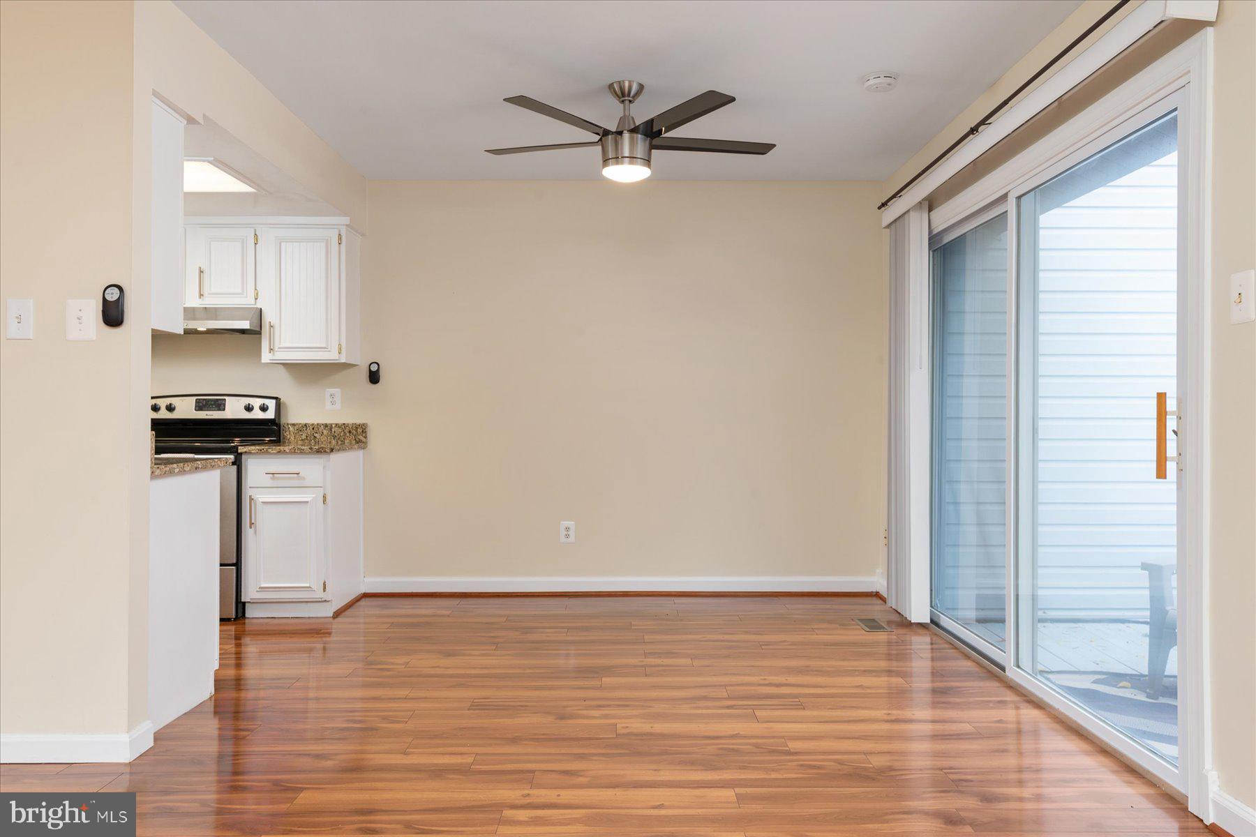 1914 Ardenwood Terrace Crofton, MD 21114 - Photo 7 of 34 a view of a kitchen with wooden floor and a ceiling fan