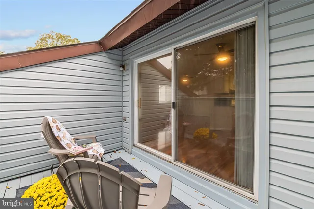 a view of a balcony with a door and a window
