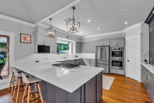 8723 Kennet Valley Road Spring, TX 77379 - Photo 7 of 38 a kitchen with stainless steel appliances kitchen island granite countertop a sink and cabinets