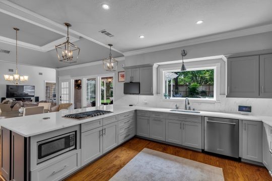 8723 Kennet Valley Road Spring, TX 77379 - Photo 8 of 38 a kitchen with a sink stove and cabinets