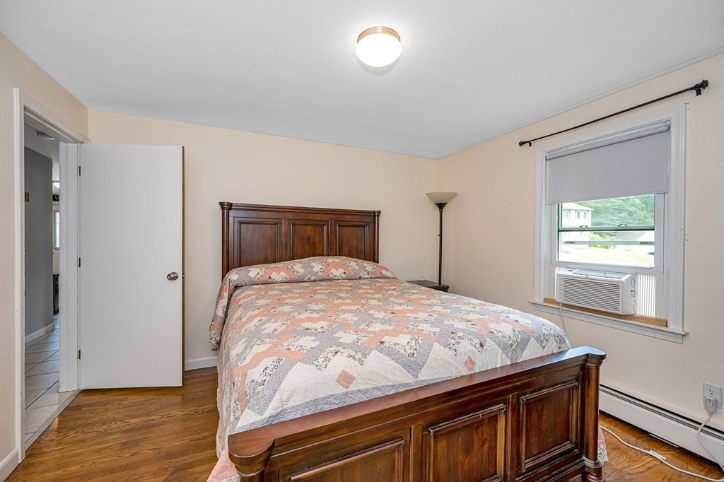 11 Cedar Circle Methuen, MA 01844 - Photo 11 of 38 a bedroom with a bed and wooden floor