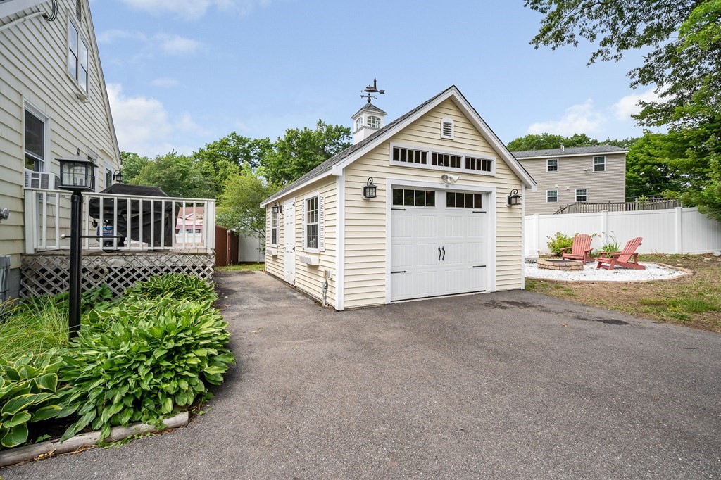 11 Cedar Circle Methuen, MA 01844 - Photo 21 of 38 a view of a white house with a small yard and a garden