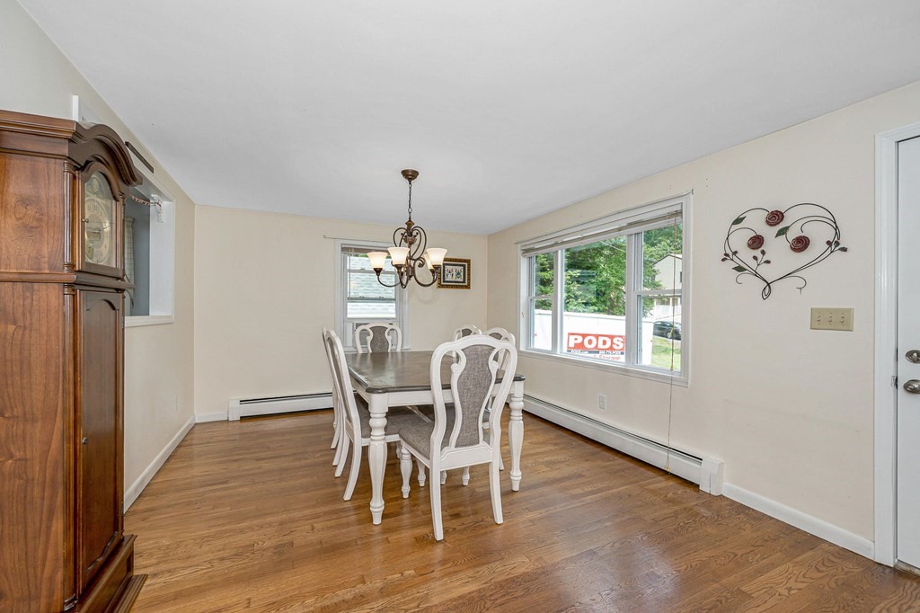 11 Cedar Circle Methuen, MA 01844 - Photo 3 of 38 a dining room with furniture a chandelier and wooden floor