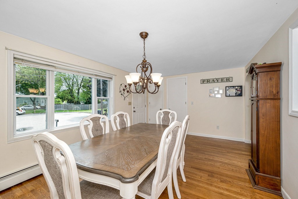 11 Cedar Circle Methuen, MA 01844 - Photo 4 of 38 a dining room with furniture a chandelier and wooden floor