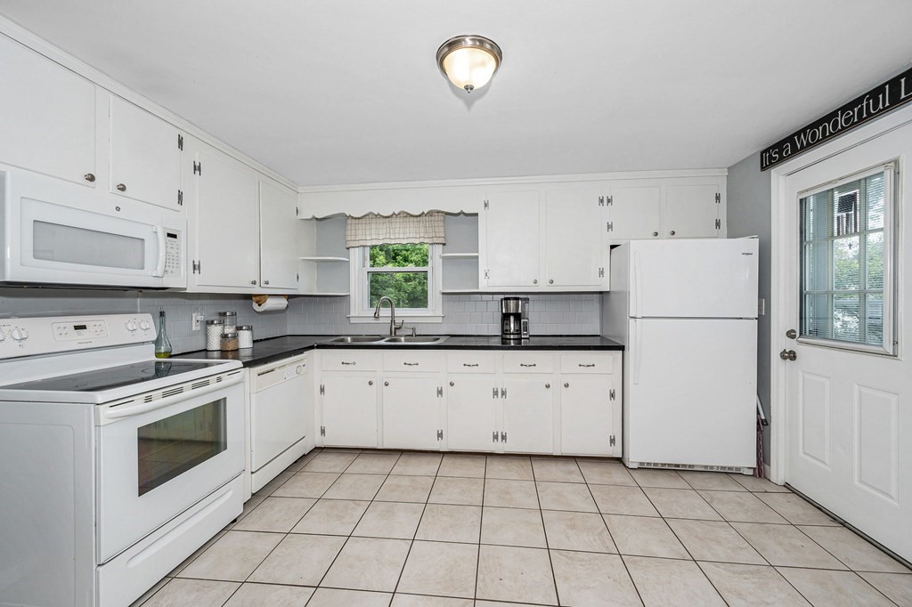 11 Cedar Circle Methuen, MA 01844 - Photo 6 of 38 a kitchen with cabinets appliances a sink and a window
