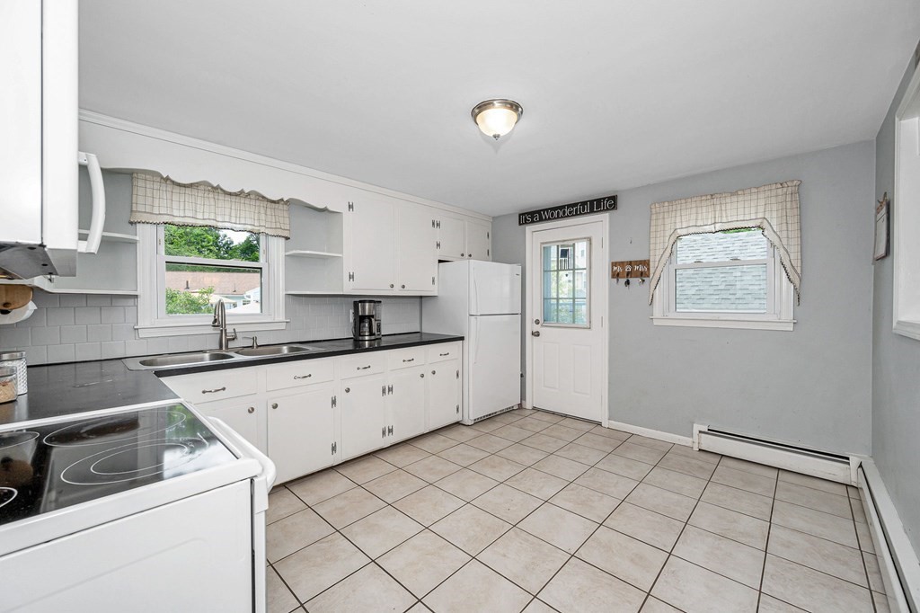 11 Cedar Circle Methuen, MA 01844 - Photo 7 of 38 a kitchen with a stove a sink and a refrigerator