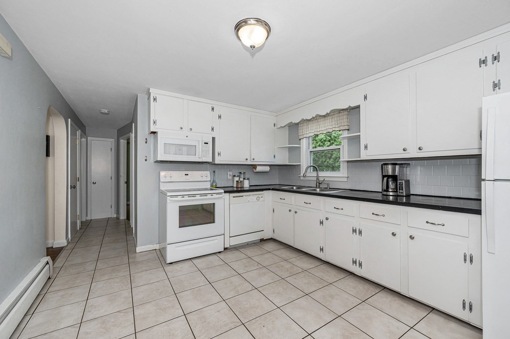 11 Cedar Circle Methuen, MA 01844 - Photo 9 of 38 a white kitchen with granite top and stainless steel appliances