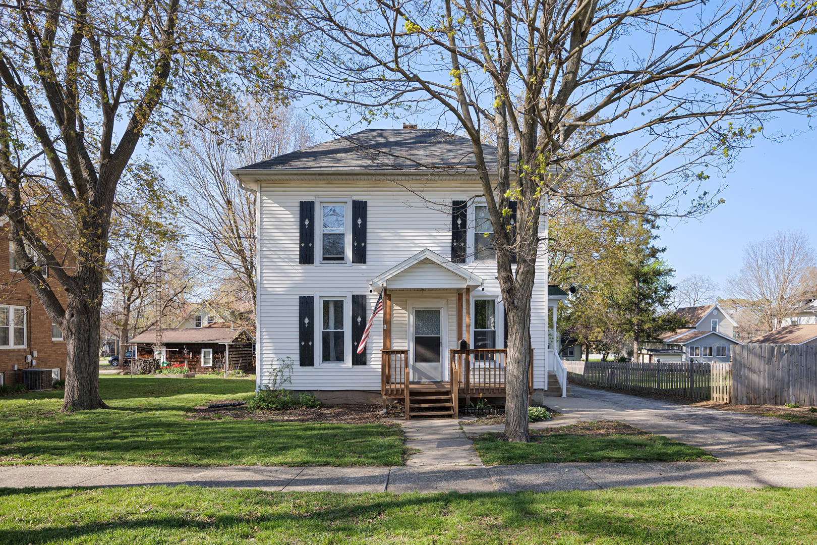 436 West Washington Street Marengo, IL 60152 - Photo 19 of 20 a front view of a house with a garden and trees