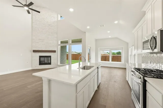 a kitchen with sink refrigerator and stove