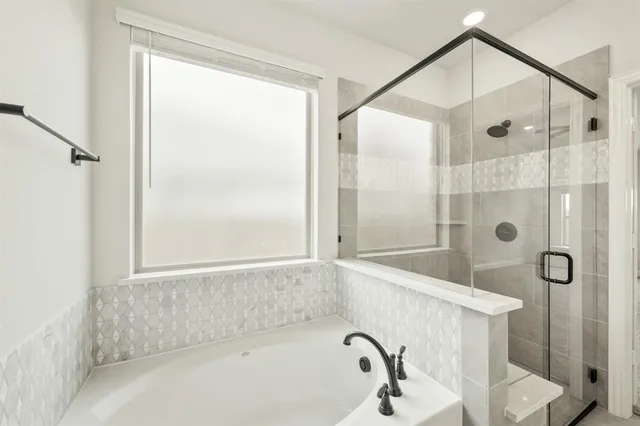 a bathroom with a bathtub and a shower