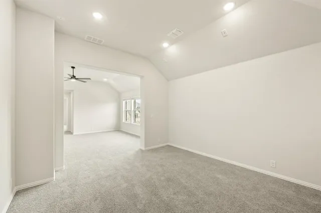 an empty room with a cabinet and a chandelier fan