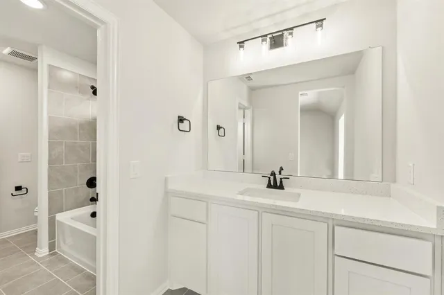 a bathroom with a sink a mirror and shower