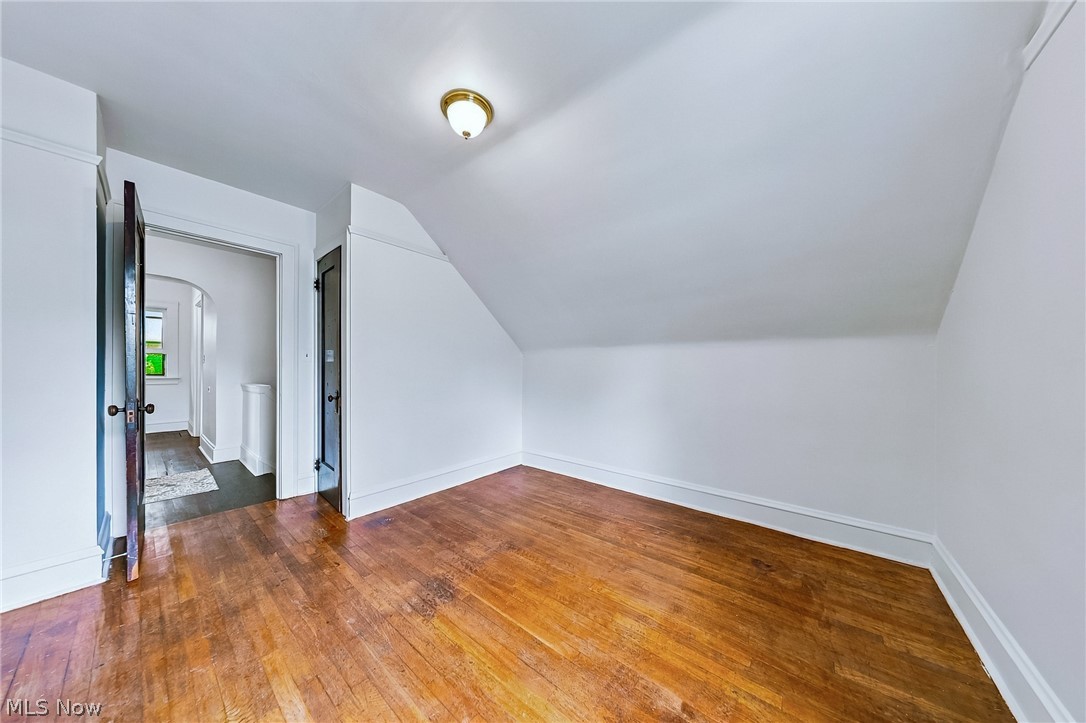 24958 Kennedy Ridge Road North Olmsted, OH 44070 - Photo 22 of 43 Wood-finish flooring, white painted walls, and a brass-finish ceiling light fixture