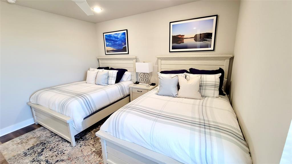 3412 Scenic Point Road, Unit 305 Graford, TX 76449 - Photo 12 of 37 a bedroom with bed and wall painting