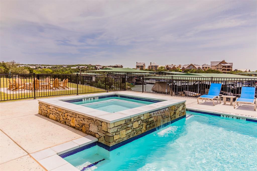 3412 Scenic Point Road, Unit 305 Graford, TX 76449 - Photo 23 of 37 a view of a swimming pool with lounge chairs