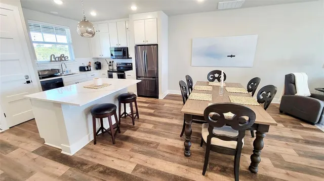 a view of a dining room with furniture and a flat screen tv
