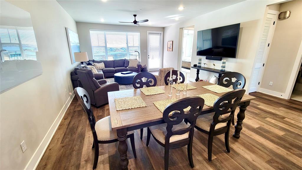 3412 Scenic Point Road, Unit 305 Graford, TX 76449 - Photo 6 of 37 a view of a dining room with furniture and a flat screen tv