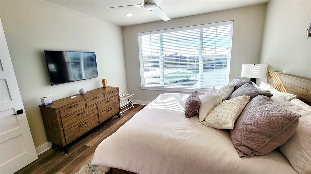 3412 Scenic Point Road, Unit 305 Graford, TX 76449 - Photo 8 of 37 a bedroom with a bed and flat screen tv