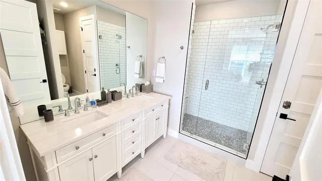 a bedroom with two beds and painting on the wall