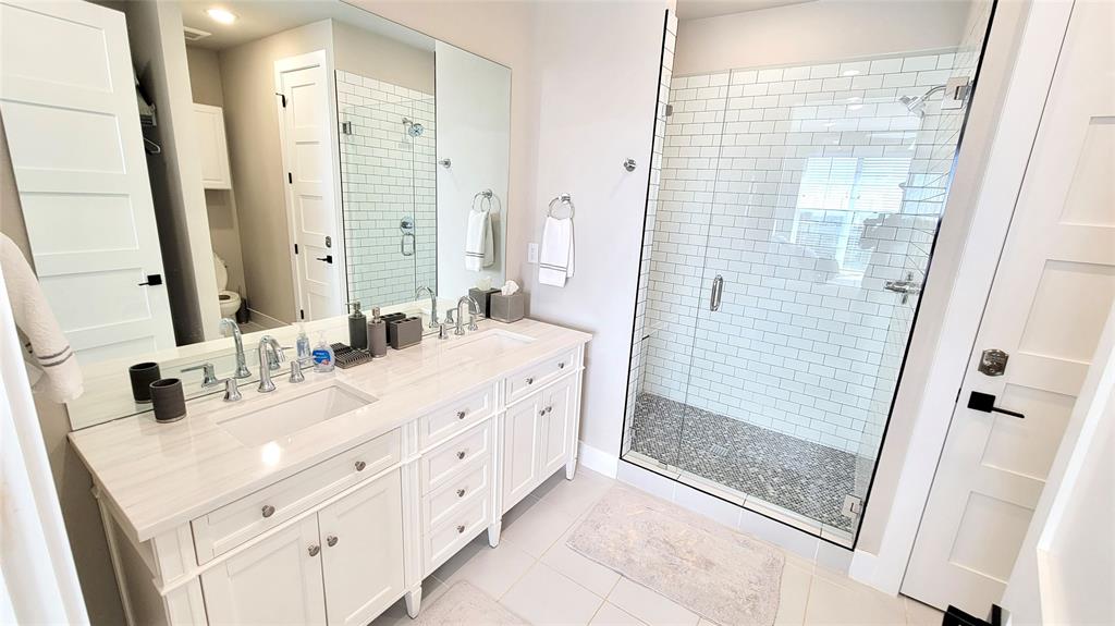3412 Scenic Point Road, Unit 305 Graford, TX 76449 - Photo 9 of 37 a bathroom with a double vanity sink mirror and shower