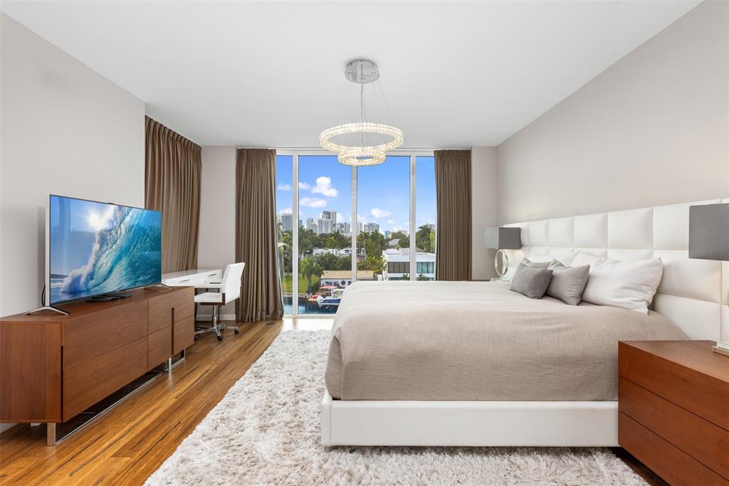 45 Hendricks Isle, Unit 403 Fort Lauderdale, FL 33301 - Photo 21 of 53 a bedroom with a bed and a flat screen tv