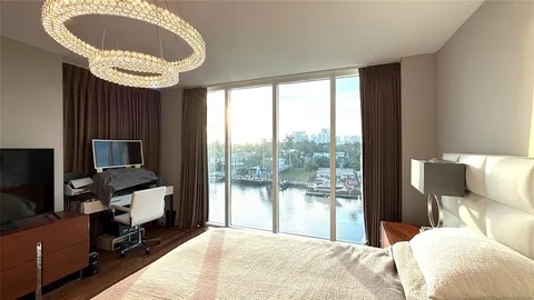 a bedroom with a large bed and a large window