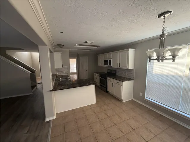 a large white kitchen with a large window