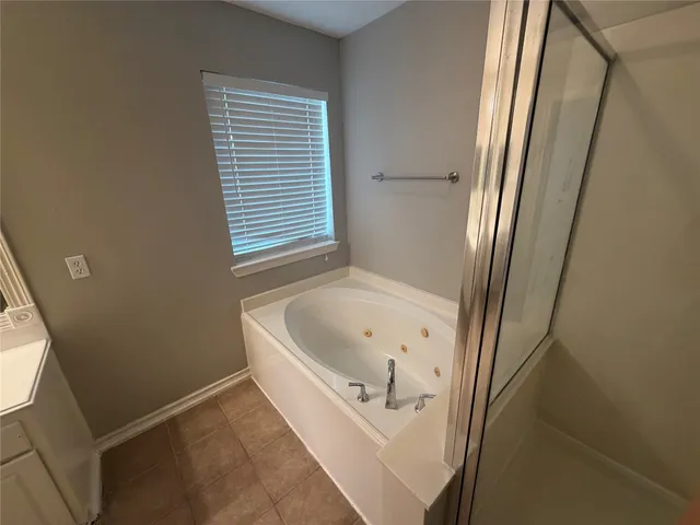 a bathroom with a tub and sink
