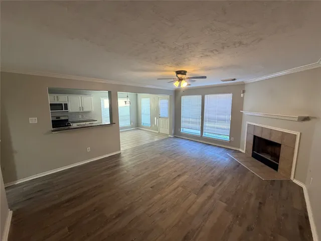 a view of an empty room with a fireplace and a window