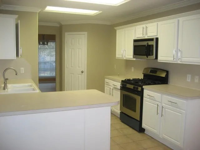 a kitchen with a sink and a stove top oven