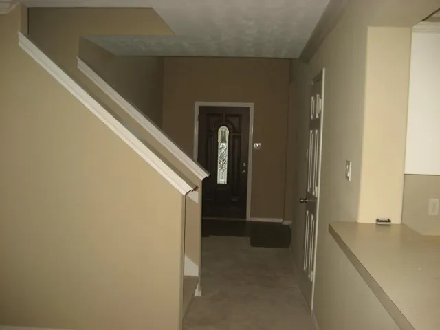 a view of a hallway with wooden shelves