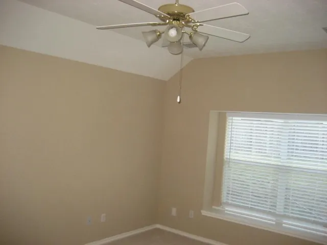 a view of a small space with a window and a fan