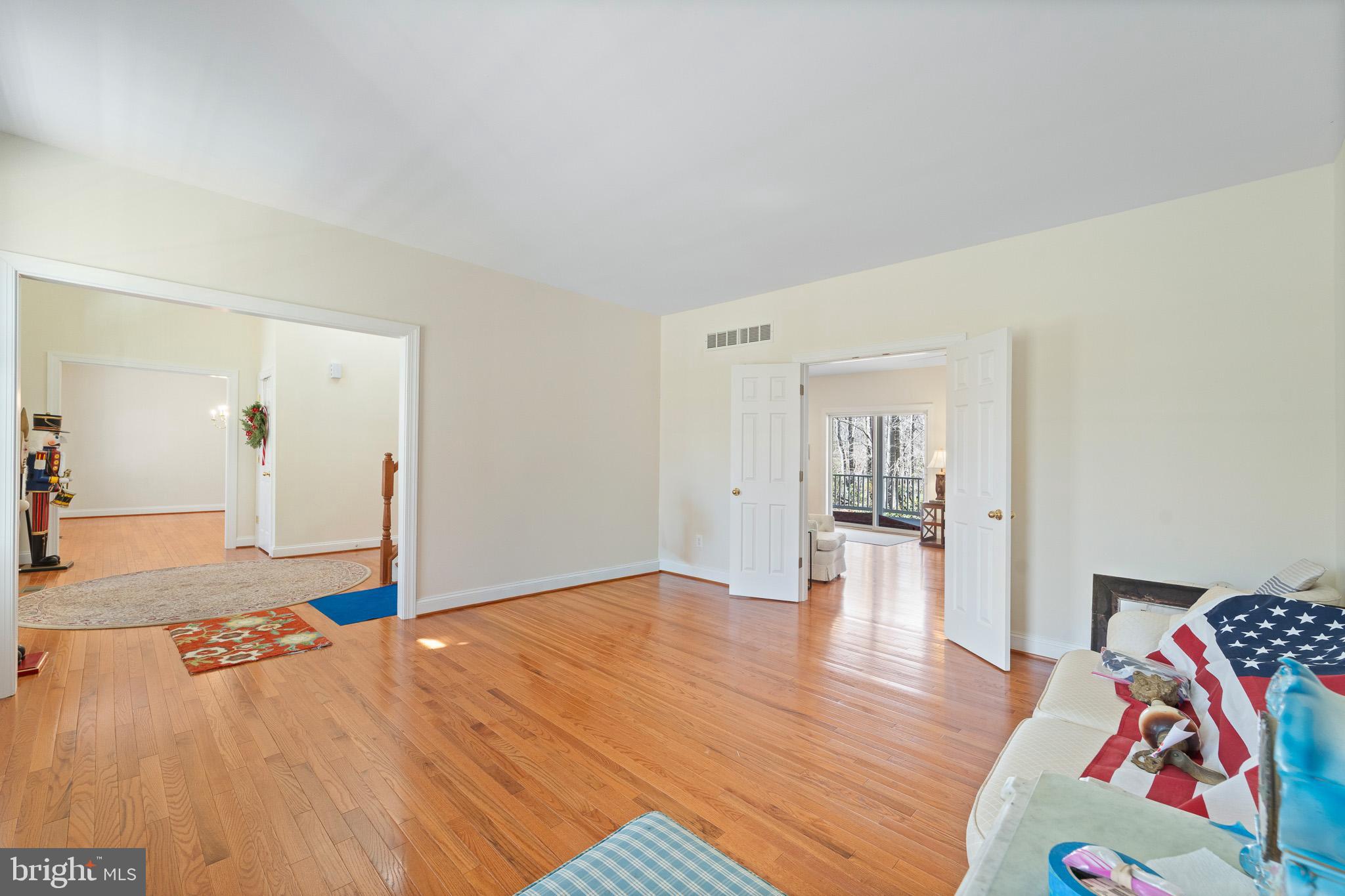 6380 Mallard Lane Lothian, MD 20711 - Photo 11 of 57 a bedroom with a bed and wooden floor