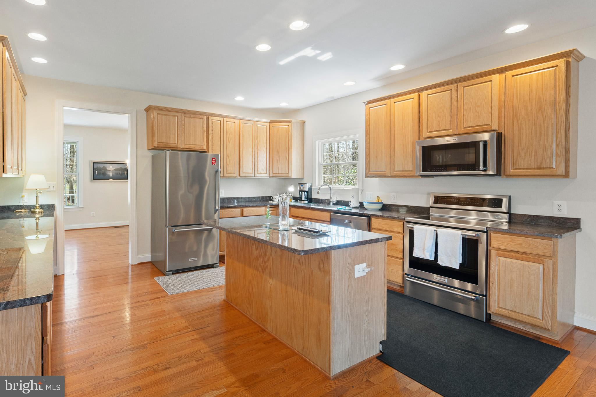 6380 Mallard Lane Lothian, MD 20711 - Photo 17 of 57 a kitchen with stainless steel appliances granite countertop a stove a sink and a refrigerator