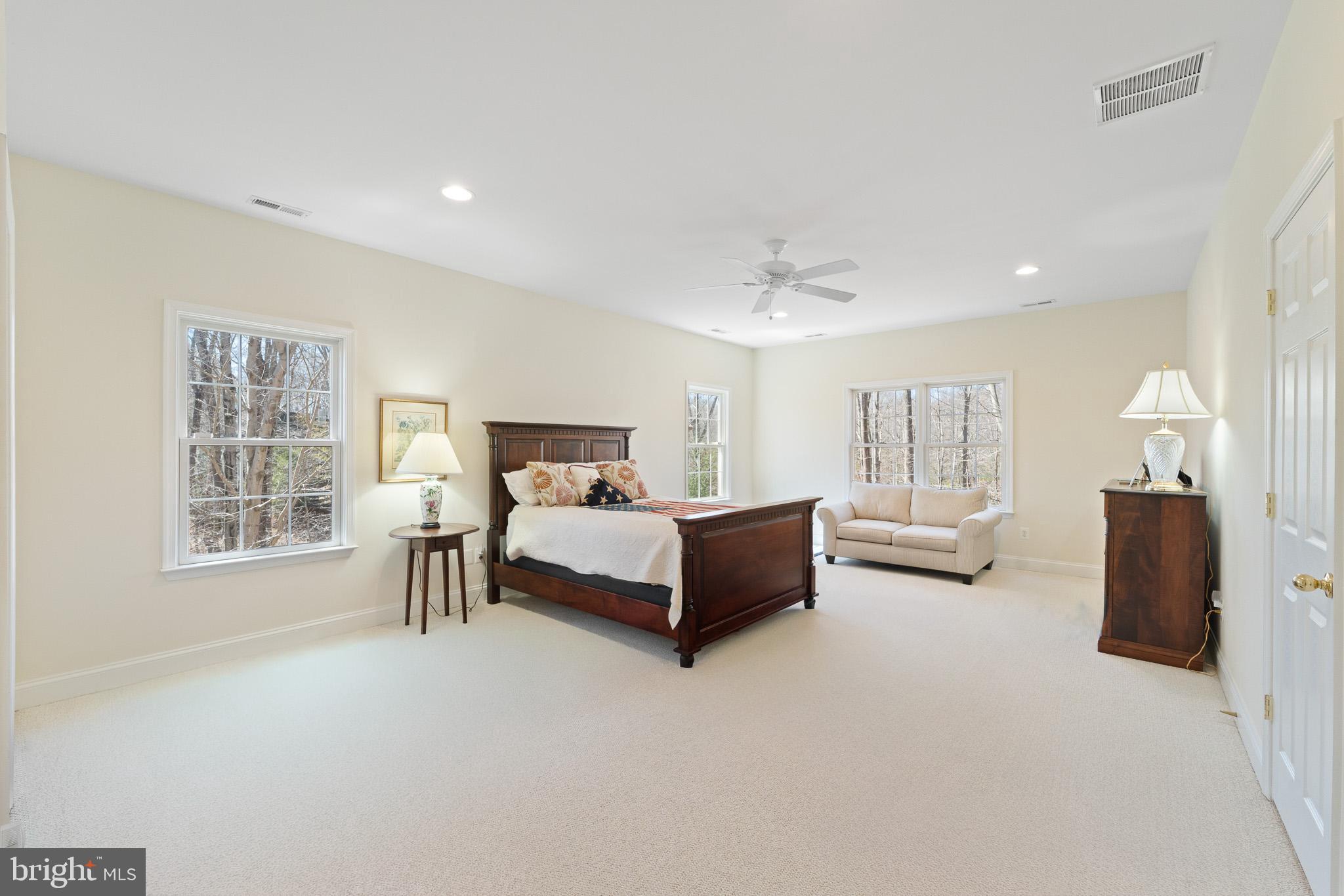 6380 Mallard Lane Lothian, MD 20711 - Photo 3 of 57 a spacious bedroom with a bed a table and painting