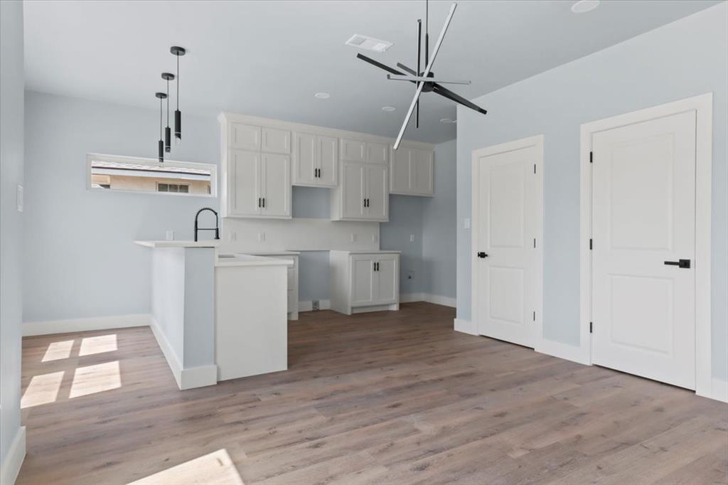 1116 East Oleander Street Fort Worth, TX 76104 - Photo 16 of 32 a view of a kitchen with wooden floor