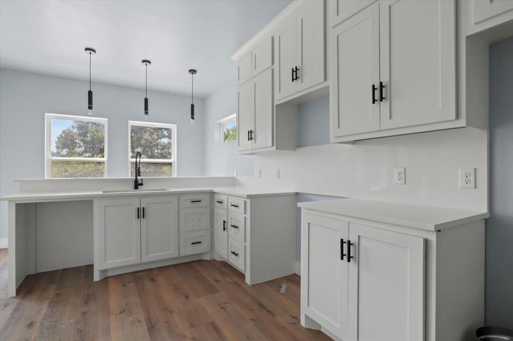 1116 East Oleander Street Fort Worth, TX 76104 - Photo 17 of 32 a kitchen with white cabinets and window