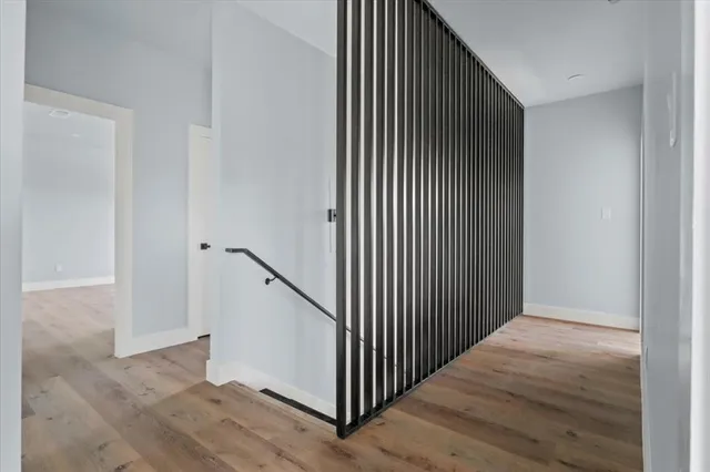 a view of a hallway with wooden floor