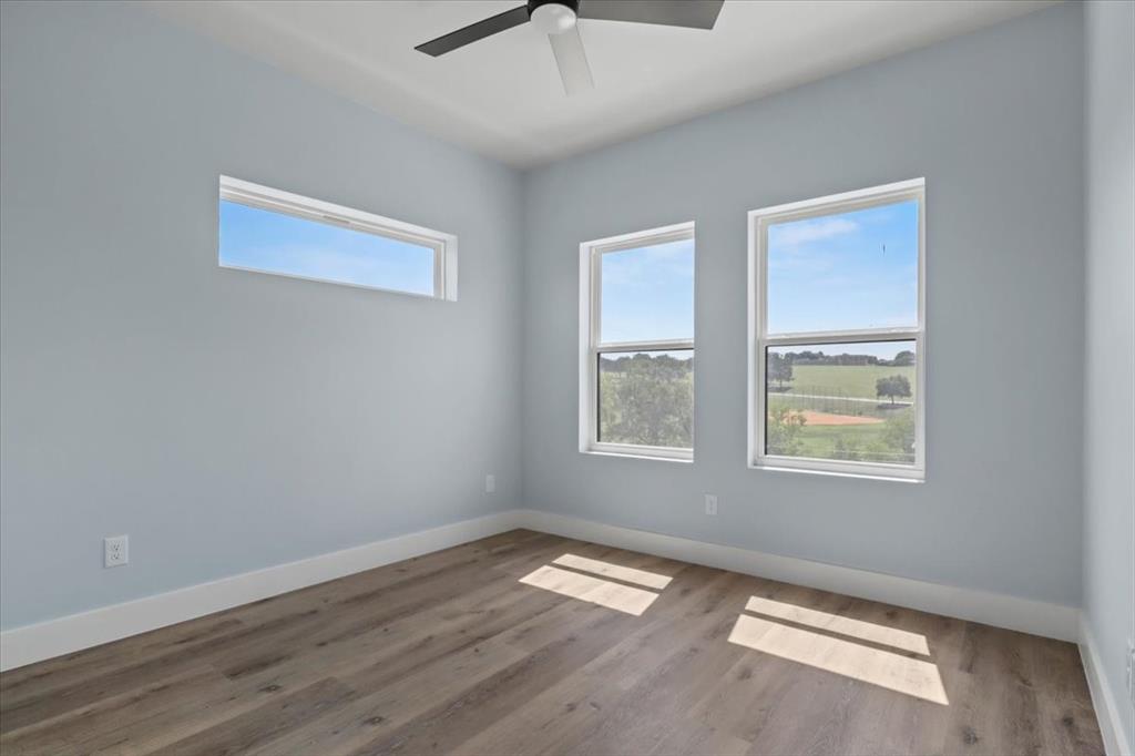 1116 East Oleander Street Fort Worth, TX 76104 - Photo 20 of 32 a view of empty room with wooden floor and fan