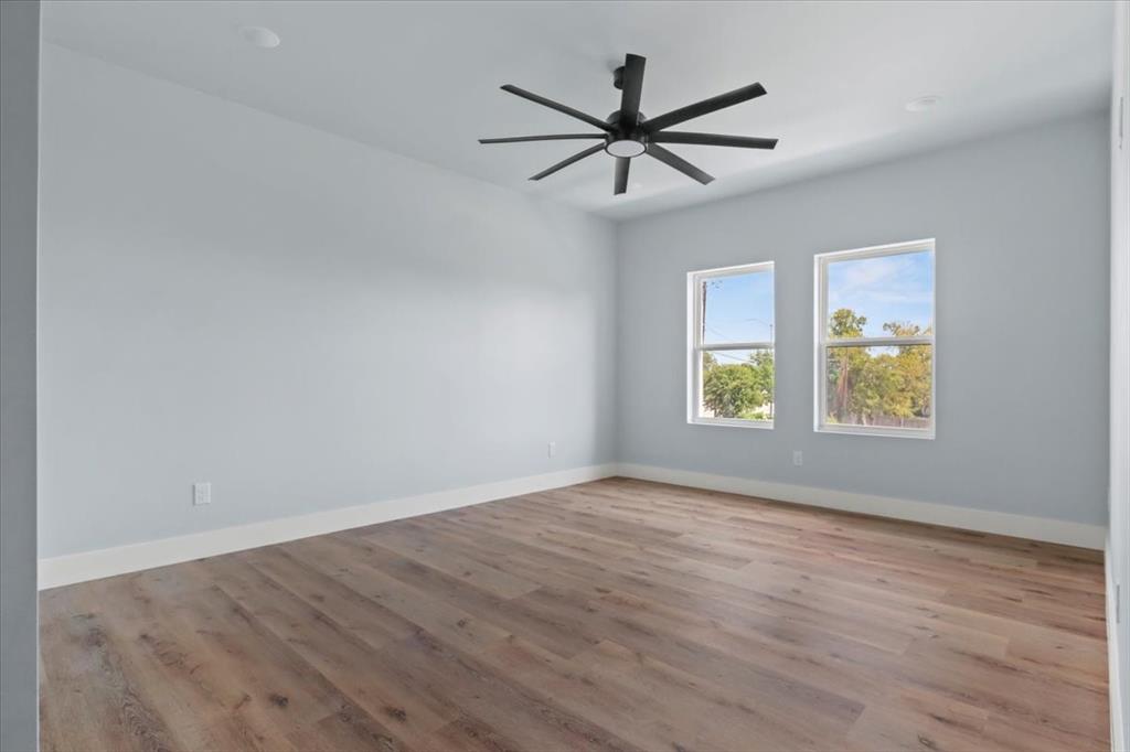 1116 East Oleander Street Fort Worth, TX 76104 - Photo 24 of 32 a view of a big room with wooden floor and windows