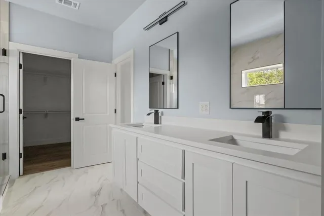 a bathroom with double sink and a mirror