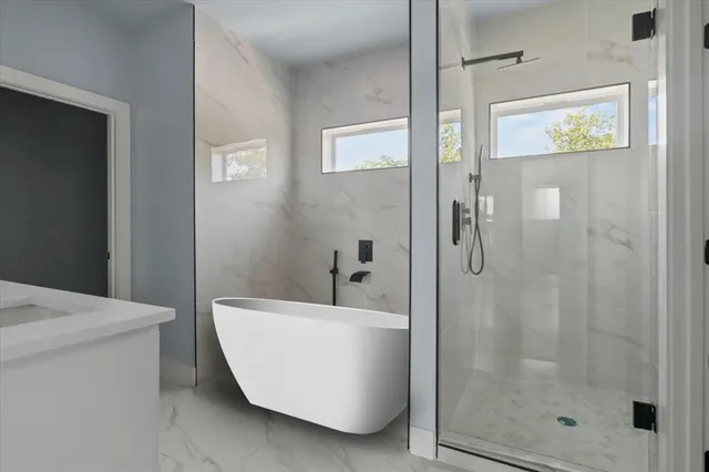 a bathroom with a bathtub and shower