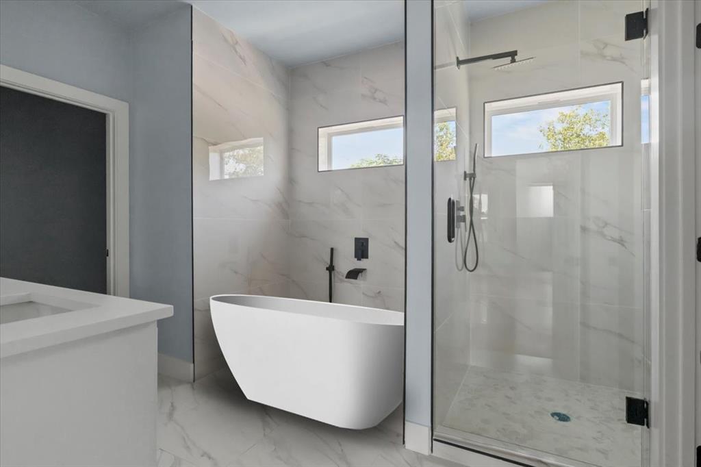 1116 East Oleander Street Fort Worth, TX 76104 - Photo 27 of 32 a bathroom with a bathtub and shower