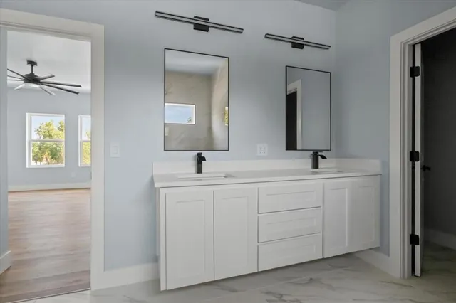 a bathroom with 2 sink and a mirror