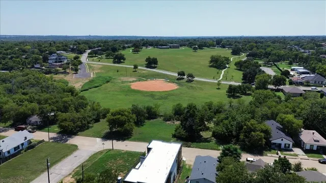 an aerial view of residential houses with outdoor space and river