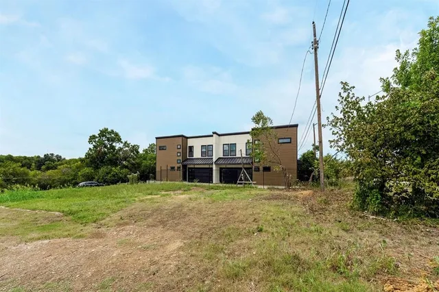 a house view with a sitting space and garden