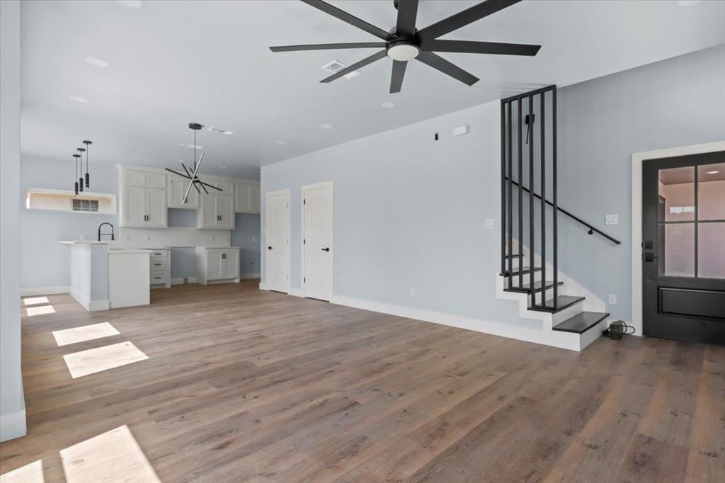1116 East Oleander Street Fort Worth, TX 76104 - Photo 8 of 32 a view of empty room with wooden floor and fan