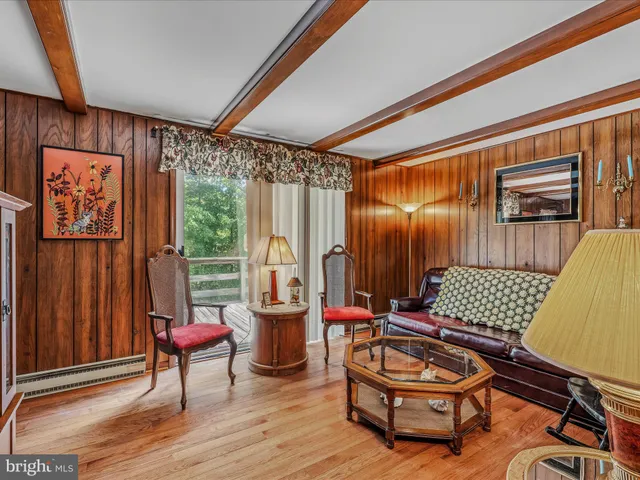 a bedroom with a bed a bookshelf and a large window