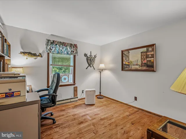 a living room with furniture and a dresser