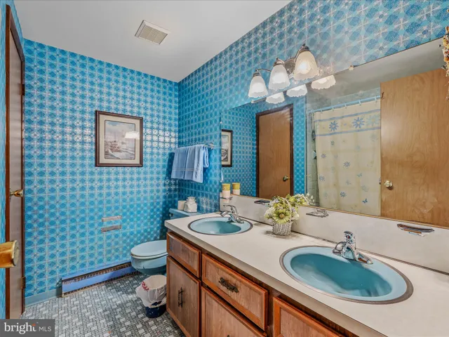 a bedroom with furniture and a large window